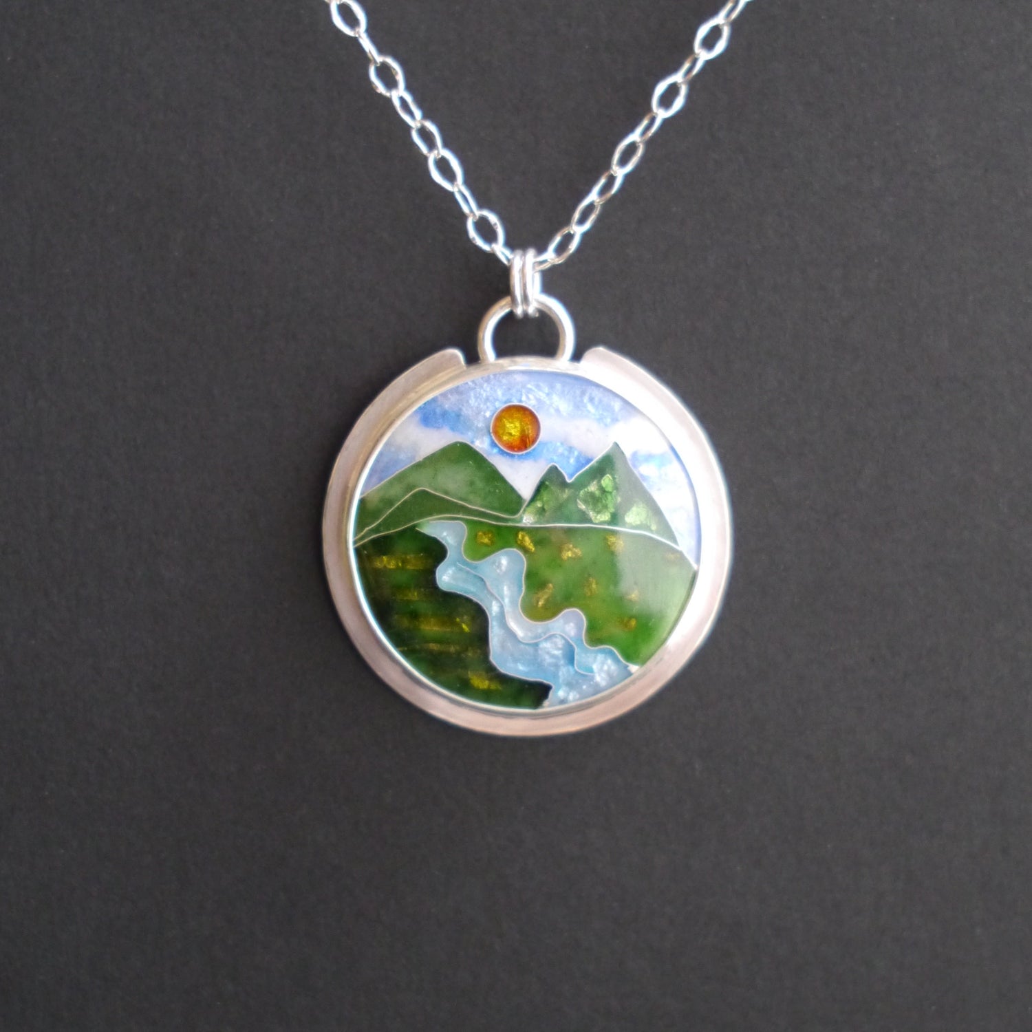Cloisonné pendant with blue and purple rolling mountains under a colorful moonlit sky